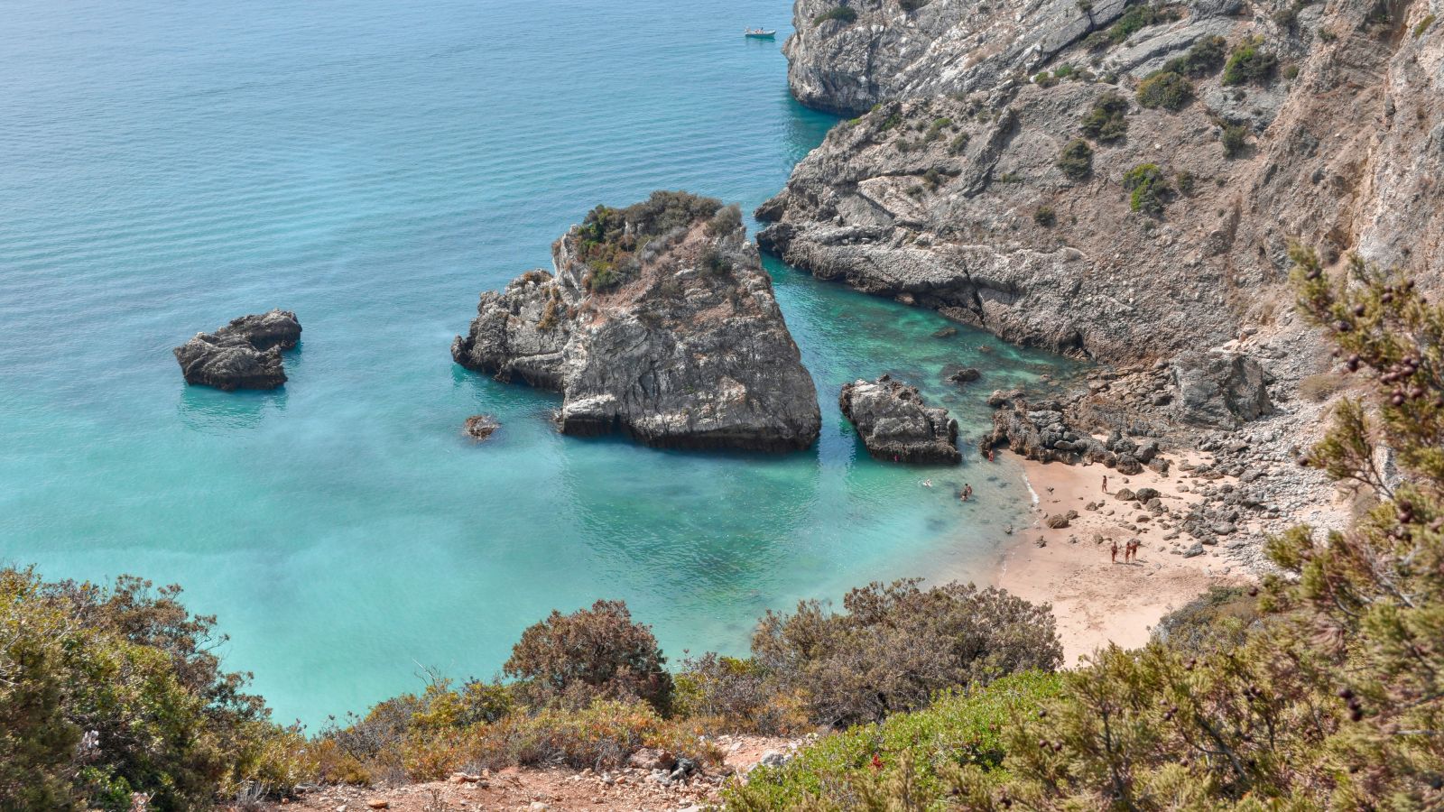 A view of a rocky beach with clear blue water