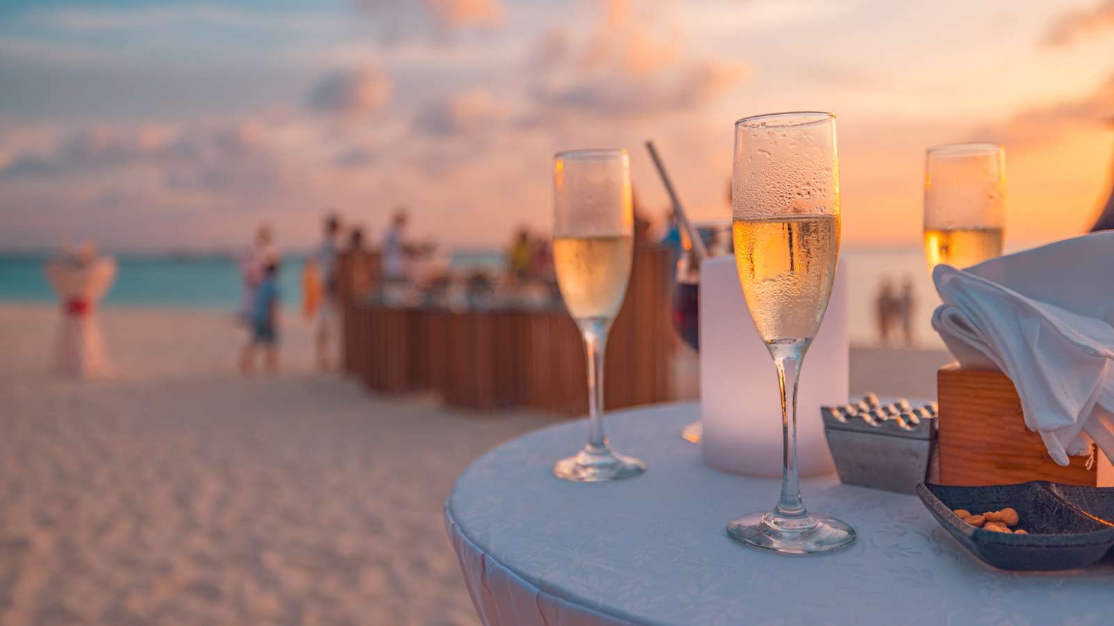 Sunset sunlight closeup glasses of champagne in a restaurant on the coast of a resort in the Maldives.