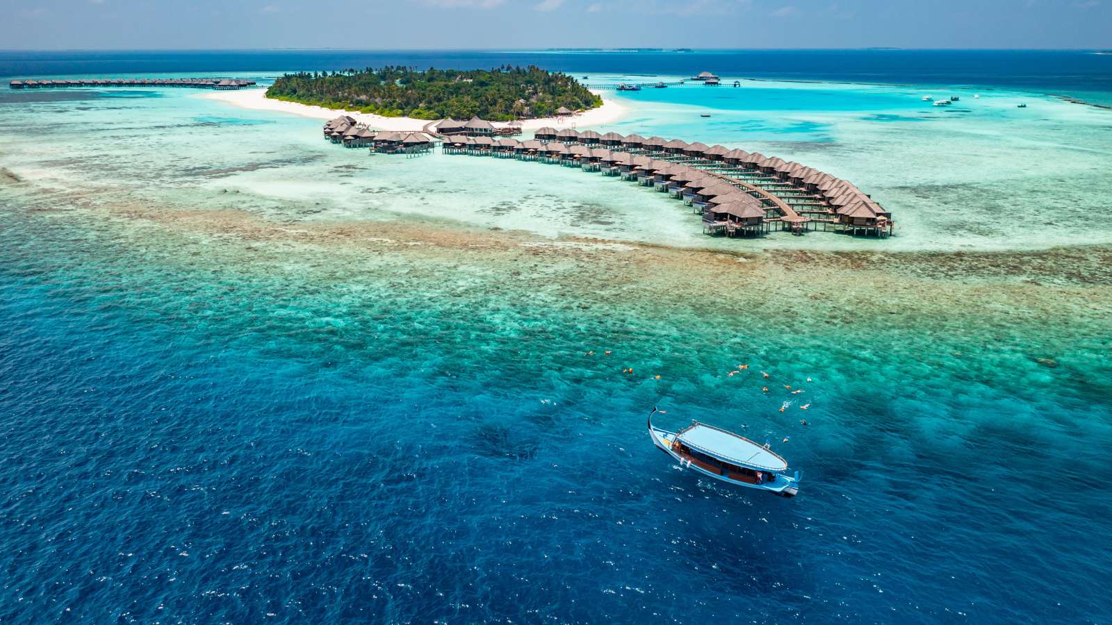 Luxury island landscape in Maldives. Sail boat blue sea water horizon reef water villas.